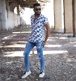 Portrait of young man wearing sunglasses standing outdoors