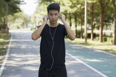 Full length of young man standing in city