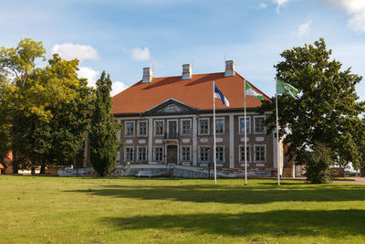 Lawn by building against sky