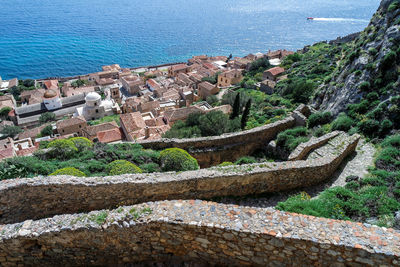 High angle view of buildings by sea