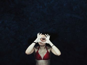 Portrait of woman in front of black background