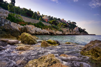 Rocks on beach against sky