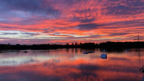 Scenic view of lake against orange sky