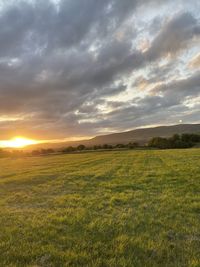 Scenic view of field against sky during sunset