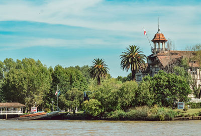 Trees and plants in river against building
