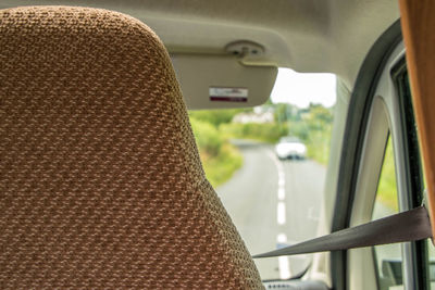 Rear view of person seen through car window