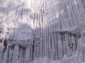 Low angle view of icicles on rock