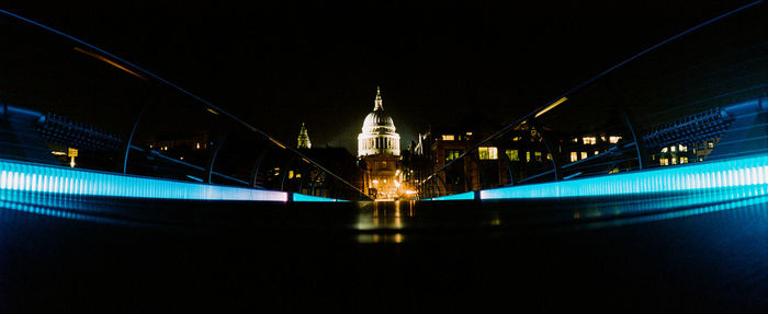 Illuminated city against clear sky at night