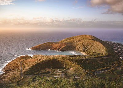 Scenic view of land by sea