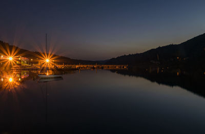 Scenic view of lake against sky at night