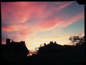 Silhouette of built structure at sunset