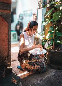 Young woman sitting outdoors