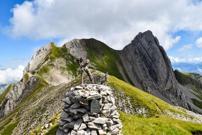 Stack of rocks on mountain against sky