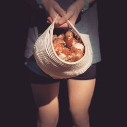 Low section of woman holding food