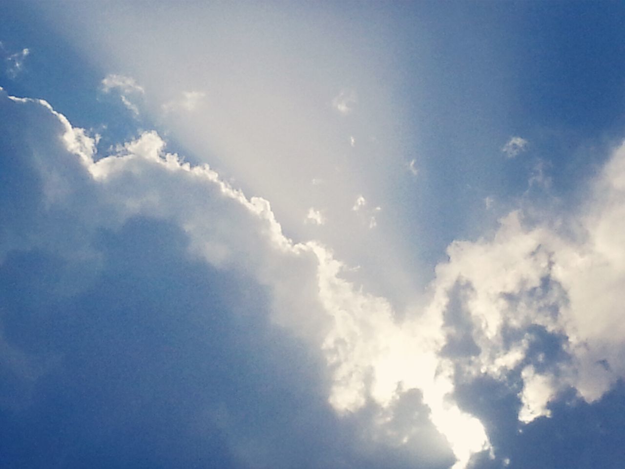 sky, low angle view, cloud - sky, beauty in nature, sky only, tranquility, blue, scenics, nature, tranquil scene, cloud, cloudy, cloudscape, idyllic, sunlight, backgrounds, outdoors, day, white color, no people