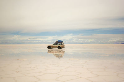 Vehicle with reflection at salar de uyuni