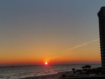 Scenic view of sea against orange sky