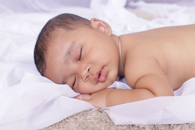 Cute baby sleeping on bed