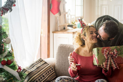 Woman sitting on sofa at home