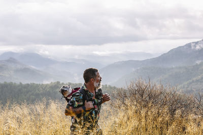 Front view of man looking at cloudy sky