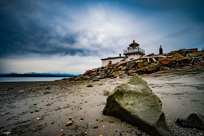 Rocks by sea against sky