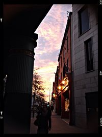 Buildings in city at sunset