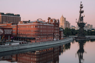 Reflection of buildings in city at waterfront