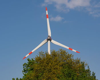 Low angle view of wind turbine against sky