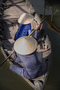 Rear view of woman working in boat