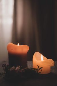 Close-up of lit candle in dark room