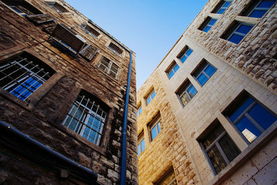 Low angle view of building against clear blue sky