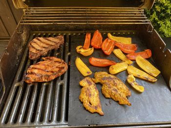 High angle view of meat on barbecue grill