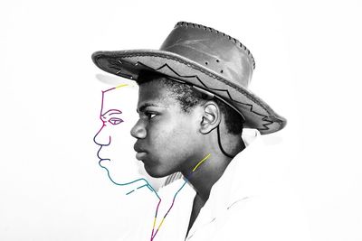 Portrait of young man looking away against white background