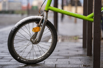 Close-up of bicycle wheel on footpath