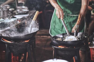 Midsection of man preparing food