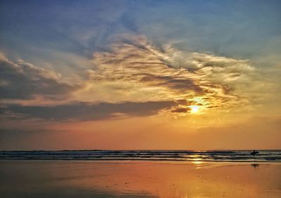 Scenic view of beach against sky during sunset