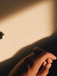 Close-up of hand on wall