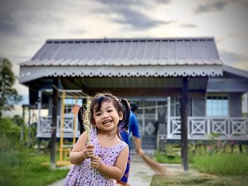 Portrait of girl against building