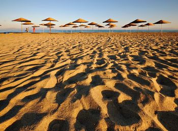 Shadow of sand on beach against sky