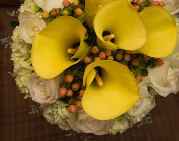 High angle view of yellow flowers on table