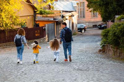 People walking on footpath in city