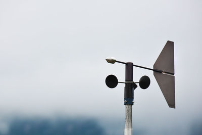 Low angle view of communications tower against sky