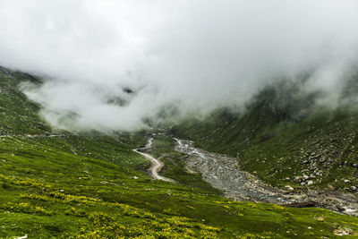 Scenic view of waterfall against sky