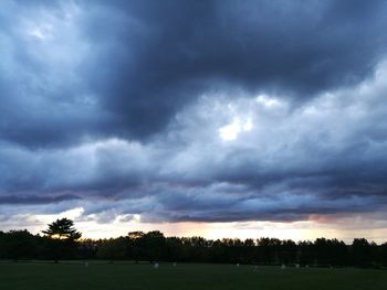 Scenic view of dramatic sky over silhouette landscape