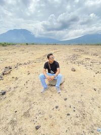 Full length of senior man sitting on land