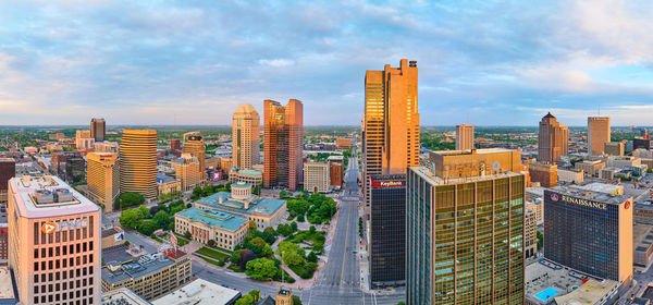 Cityscape against cloudy sky