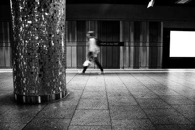 Woman standing on footbridge