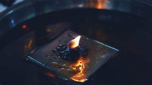 High angle view of burning candle