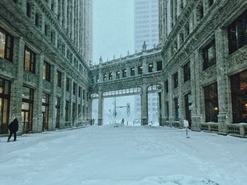 Snow covered buildings in city