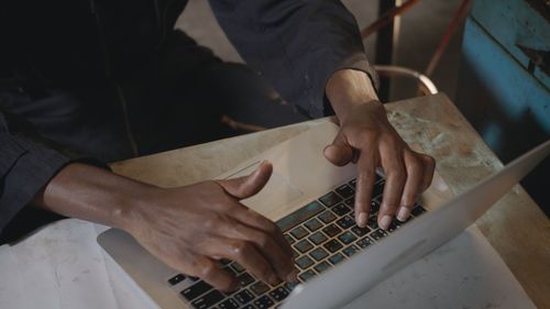 Midsection of man using laptop